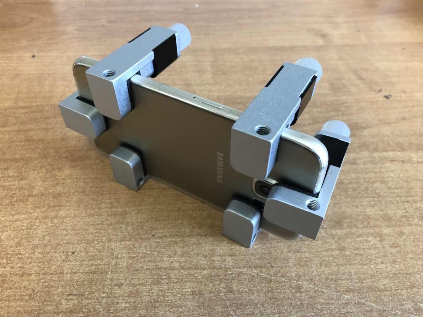 Clamp - regulated holder for mobile phone